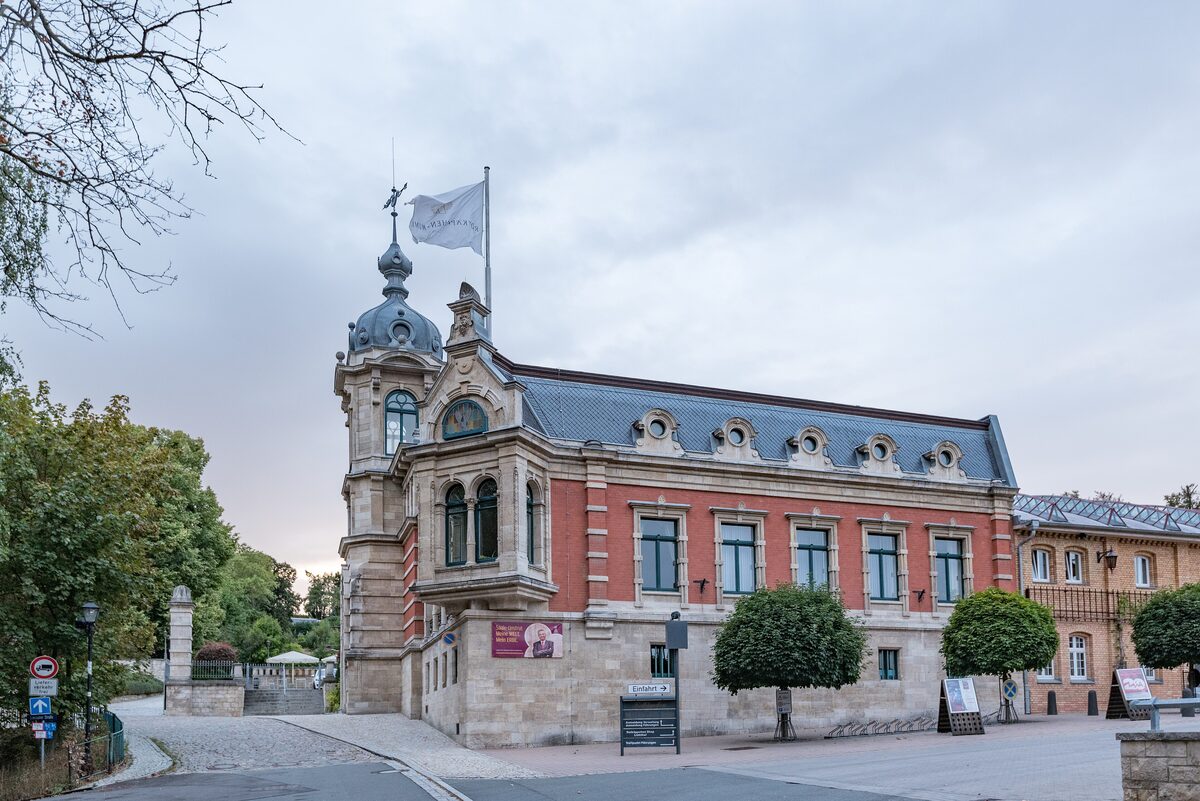 The red-brick and sandstone Rotkäppchen sparkling wine building in Freyburg, with a small domed tower and a flag