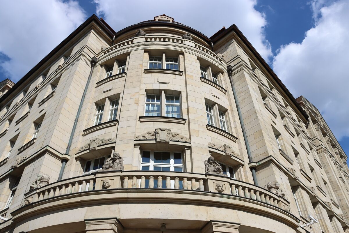 The curved corner of the Runde Ecke building, a stone facade with a balcony and tall windows