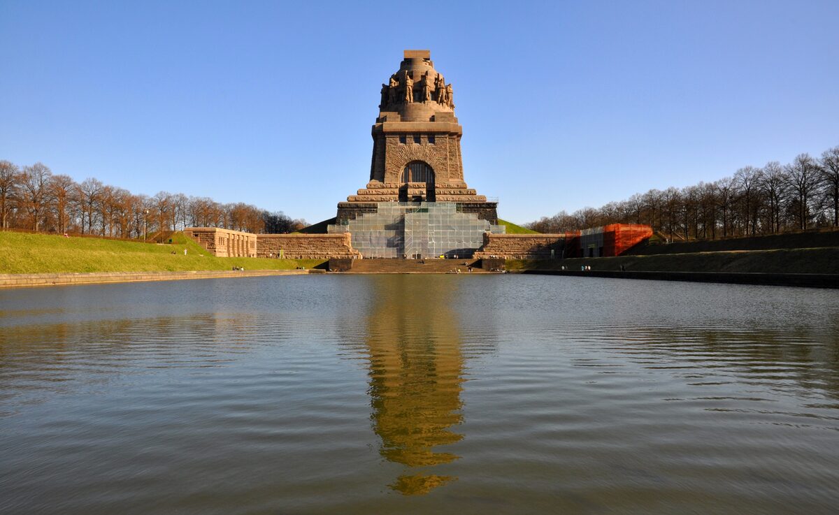 The Monument to the Battle of the Nations rising behind its reflecting pool
