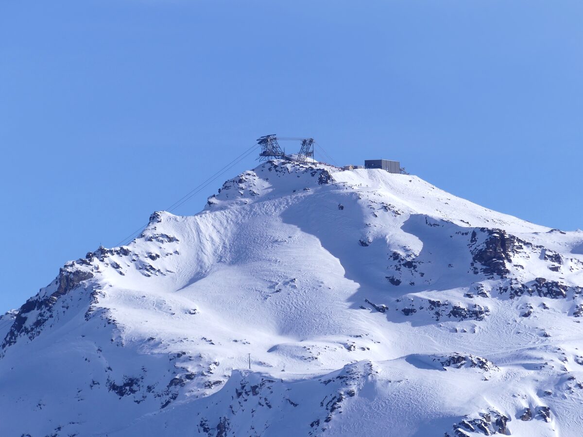 The snowy Cime de Caron summit and its station, seen from the Pointe de la Masse