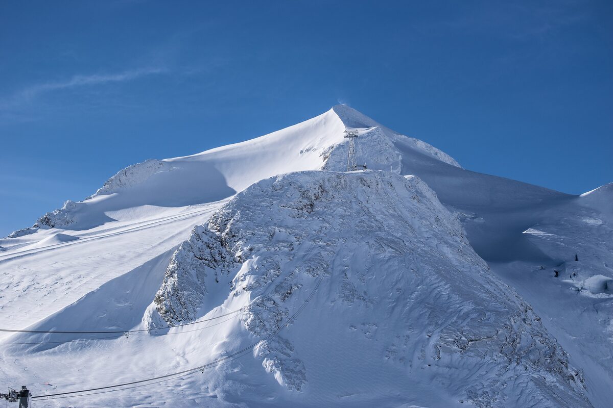 The snowy Grande Motte glacier and peak above Tignes under a clear blue sky