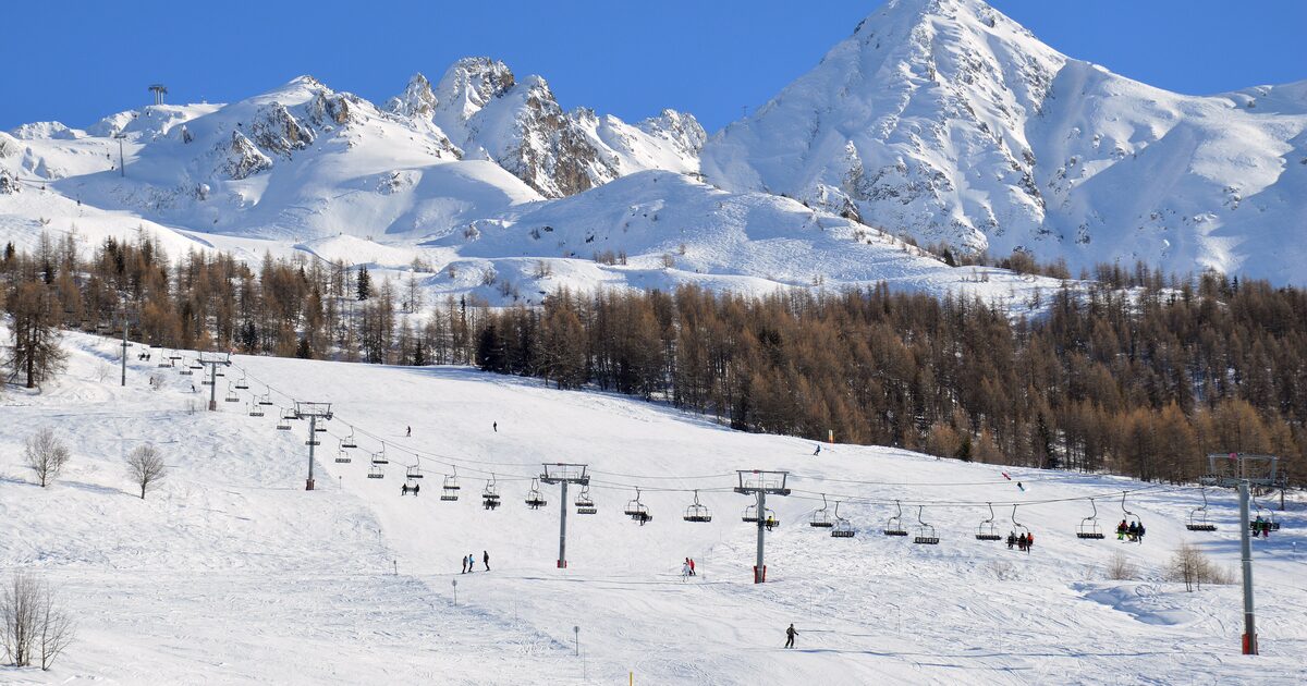 Chairlifts and ski runs under the Aiguille Grive peaks on a bright winter day above Les Arcs