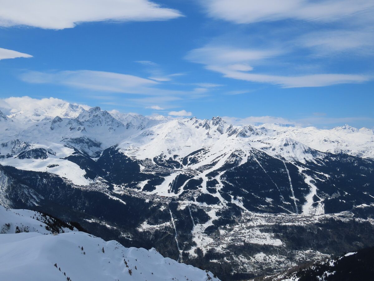 Courchevel's ski area from above, with snowy runs and lifts spread across the slopes