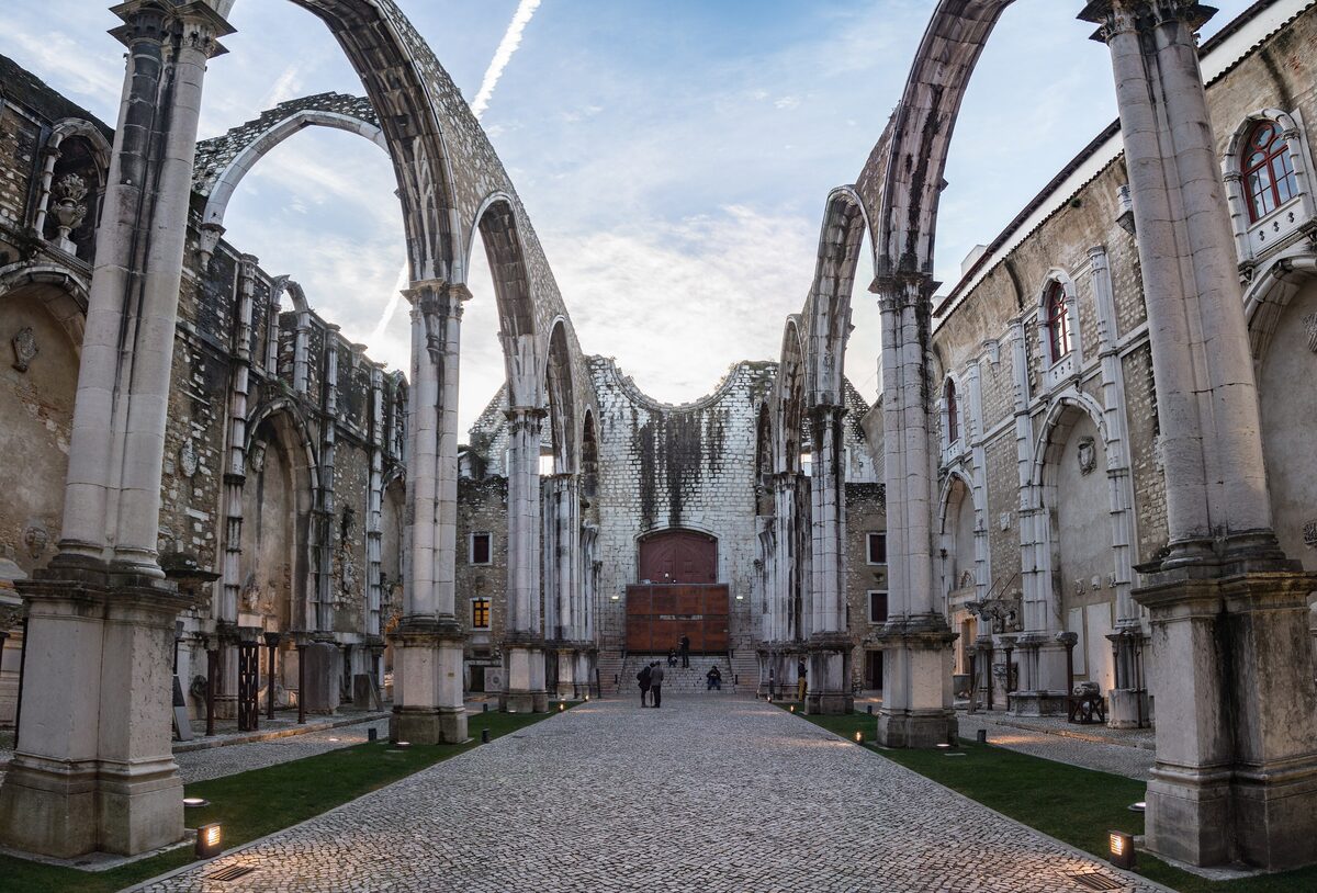 The roofless Gothic nave of the Carmo convent, its pointed arches open to the sky