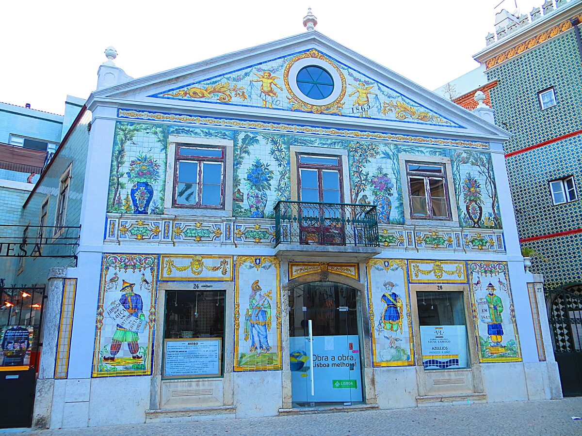 The Viúva Lamego tile factory facade at Largo do Intendente, covered in colorful azulejo panels with painted figures