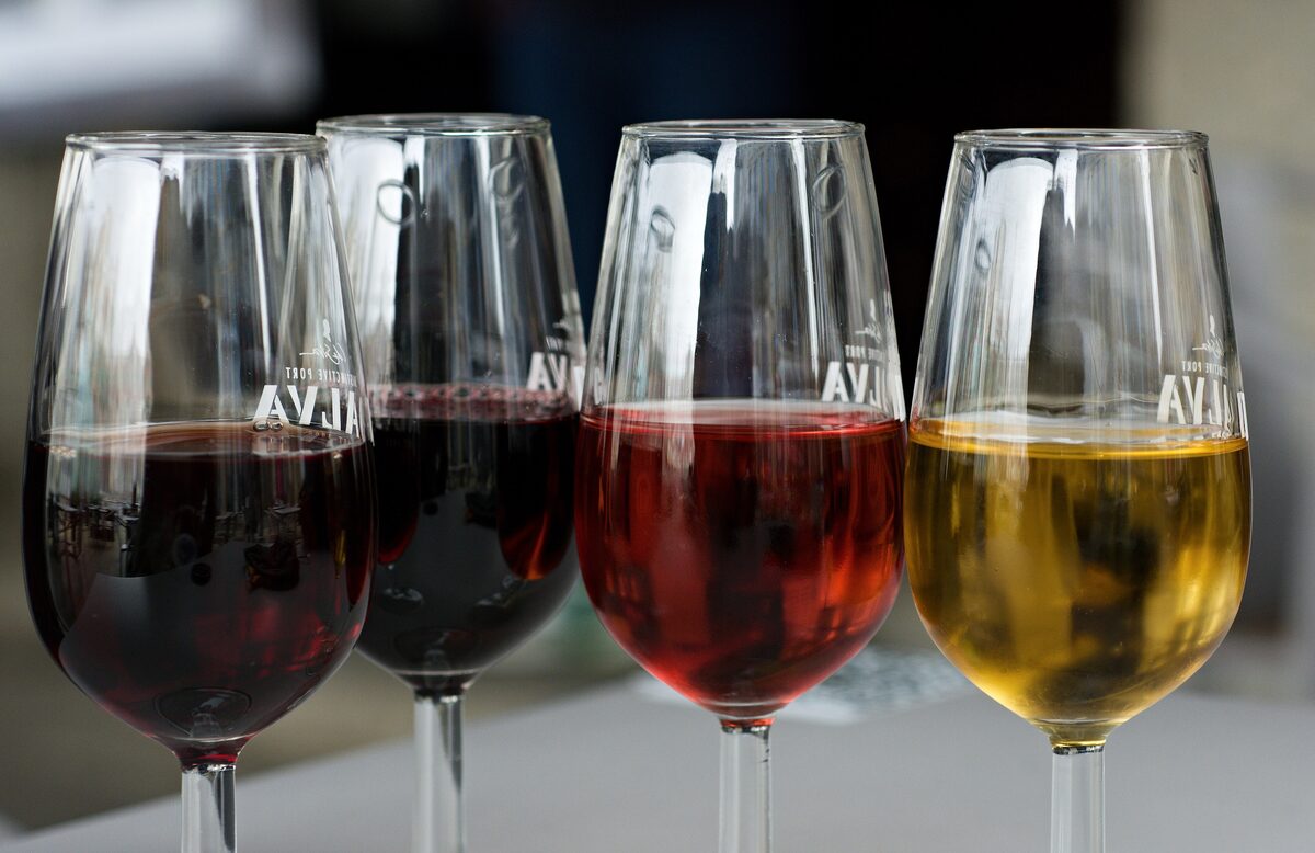 Four tasting glasses of port in colors from ruby and tawny to rosé and white