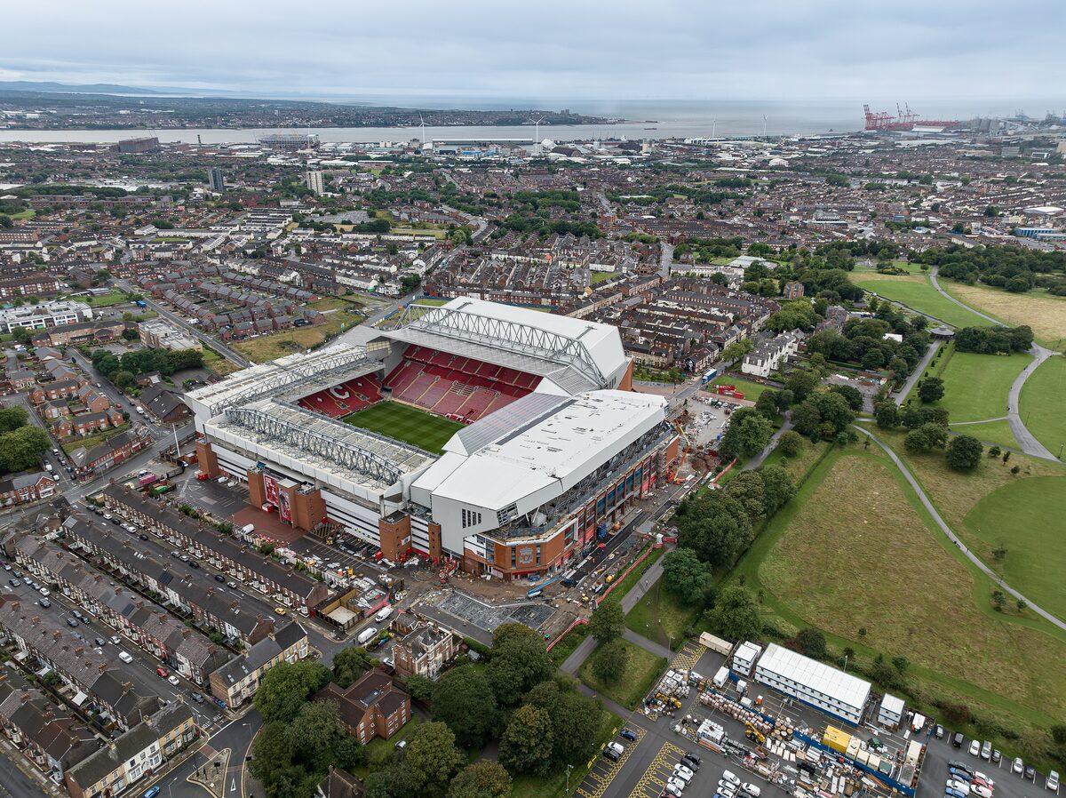 Aerial view of Anfield stadium in Liverpool, with its red seats and the terraced streets and Stanley Park around it