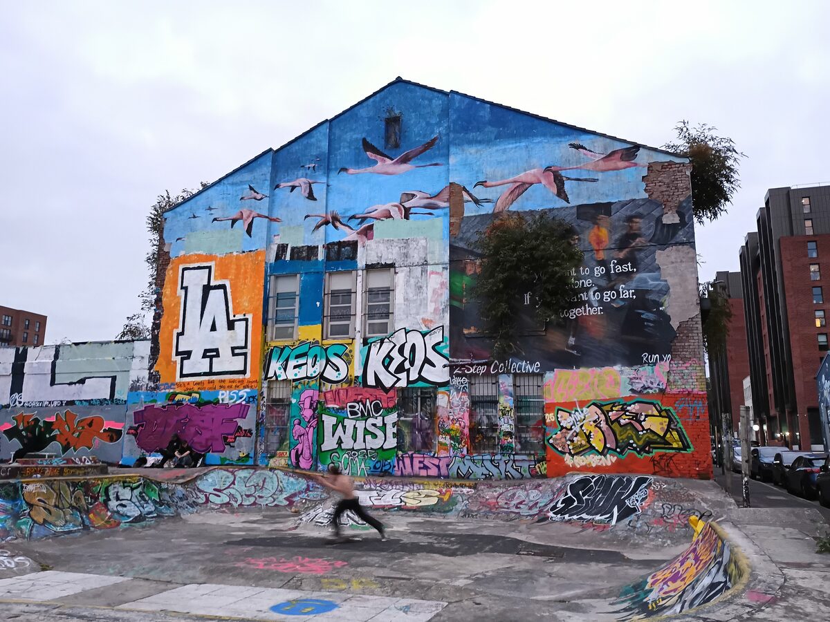 Colorful street art painted on the brick wall of an old warehouse in the Baltic Triangle in Liverpool