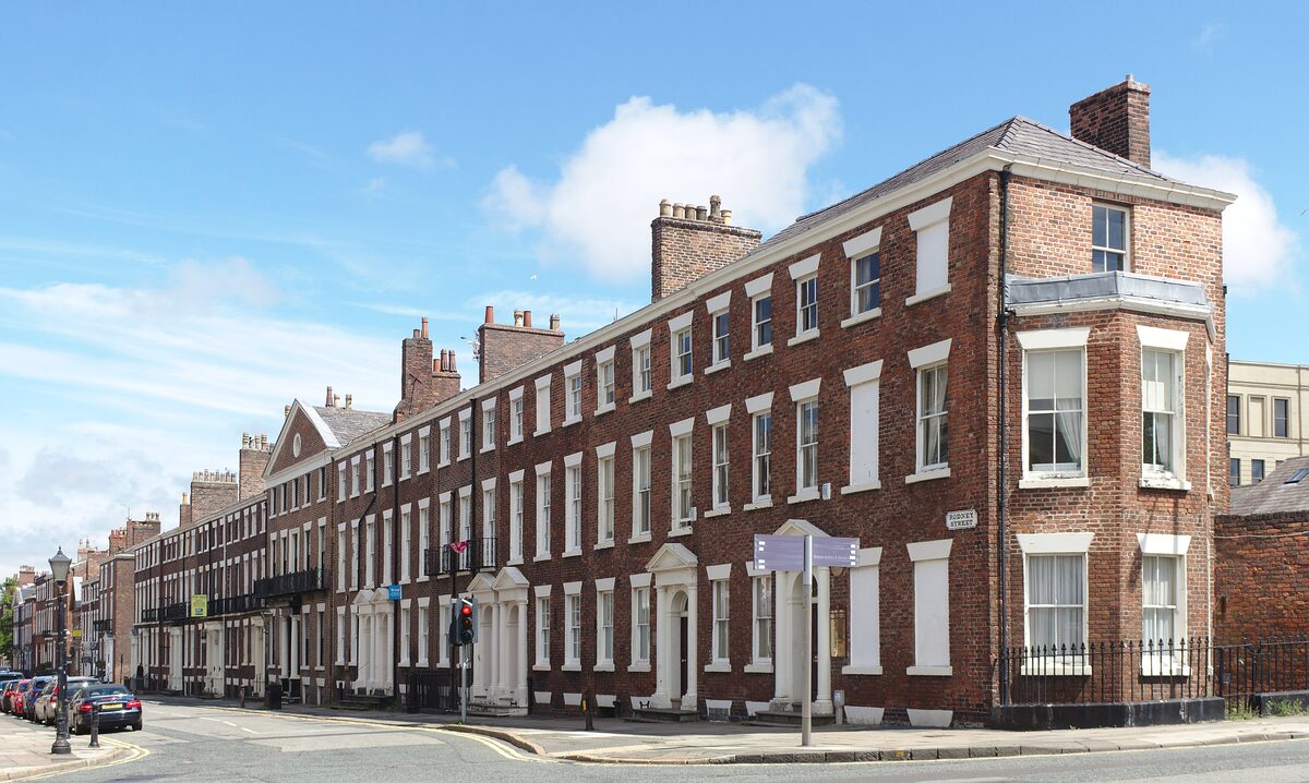 A row of Georgian brick townhouses with colorful front doors and fanlights in Liverpool's Georgian Quarter