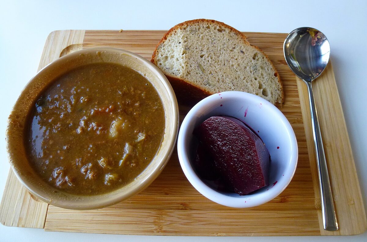 A bowl of scouse, a thick stew of meat, potatoes and vegetables, with bread and pickled red cabbage