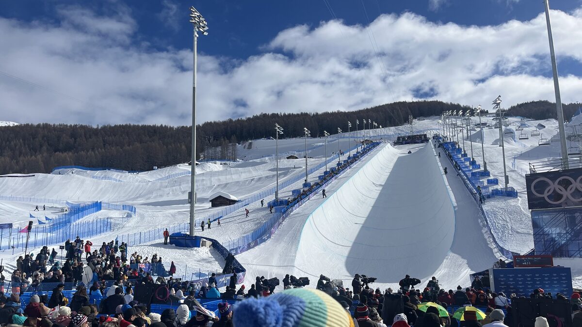 The halfpipe of the Livigno Snow Park at the 2026 Winter Olympics, with spectators in the stands