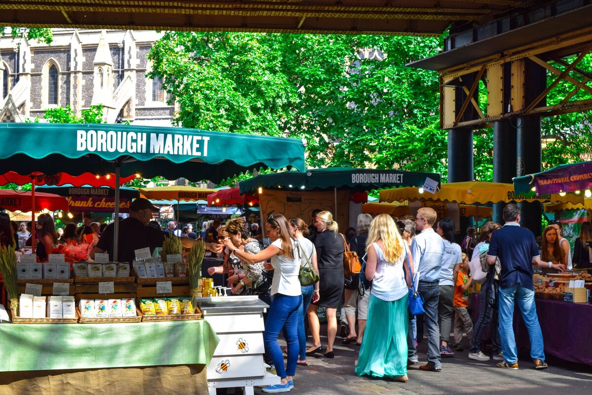 Shoppers among the food stalls of Borough Market under its iron and glass roof
