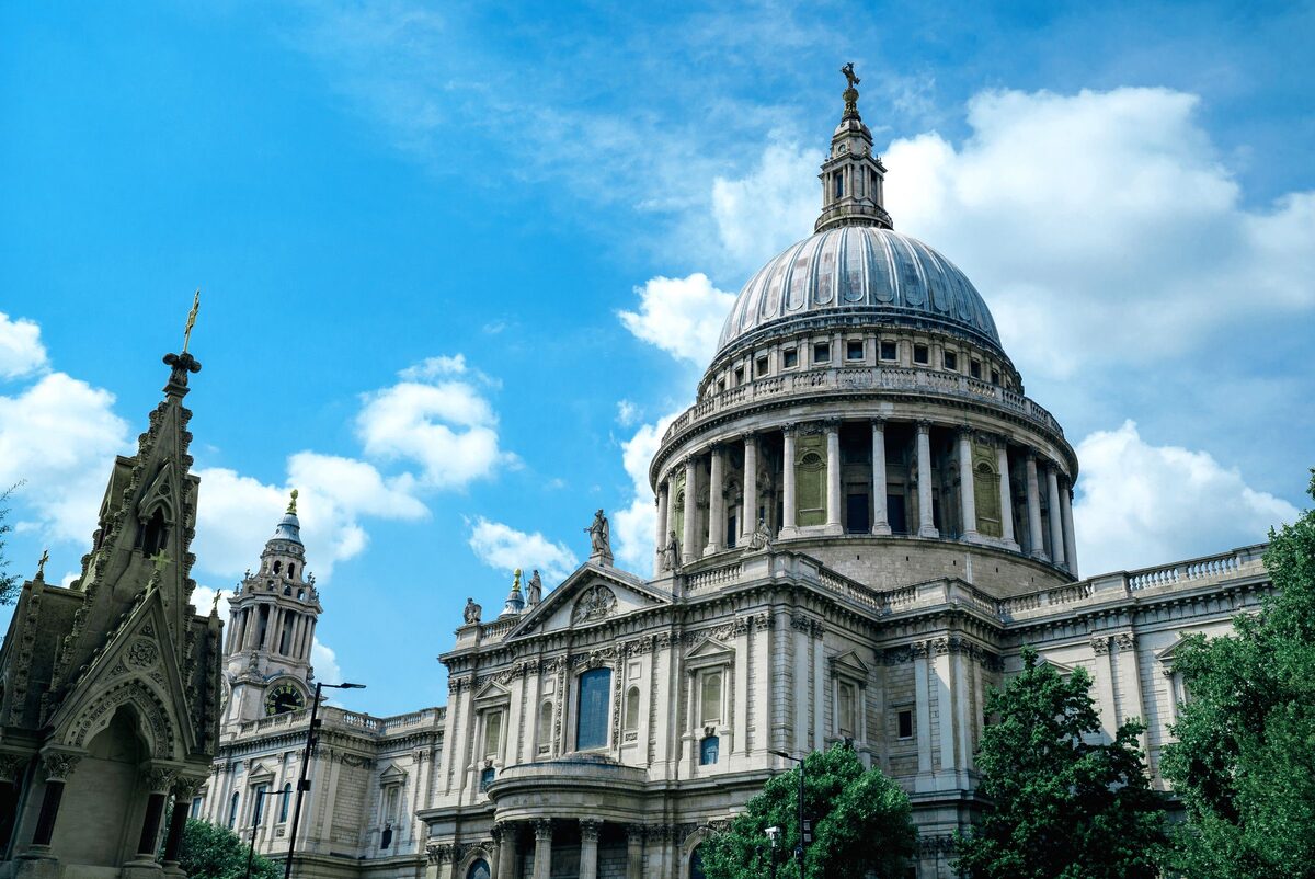 The great dome of St Paul's Cathedral in London with its columns and lantern under a blue sky