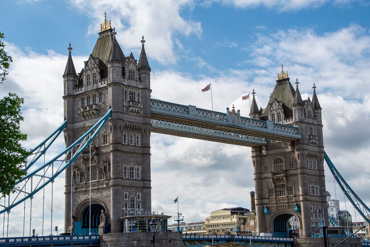 Tower Bridge in London, with its two Gothic towers and blue walkways, over the Thames