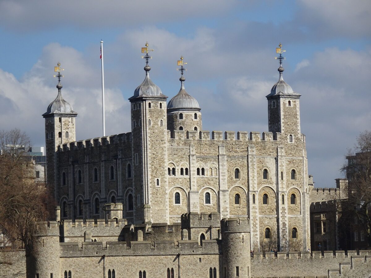 The White Tower, the square Norman keep of the Tower of London, with its four corner turrets, behind the outer walls