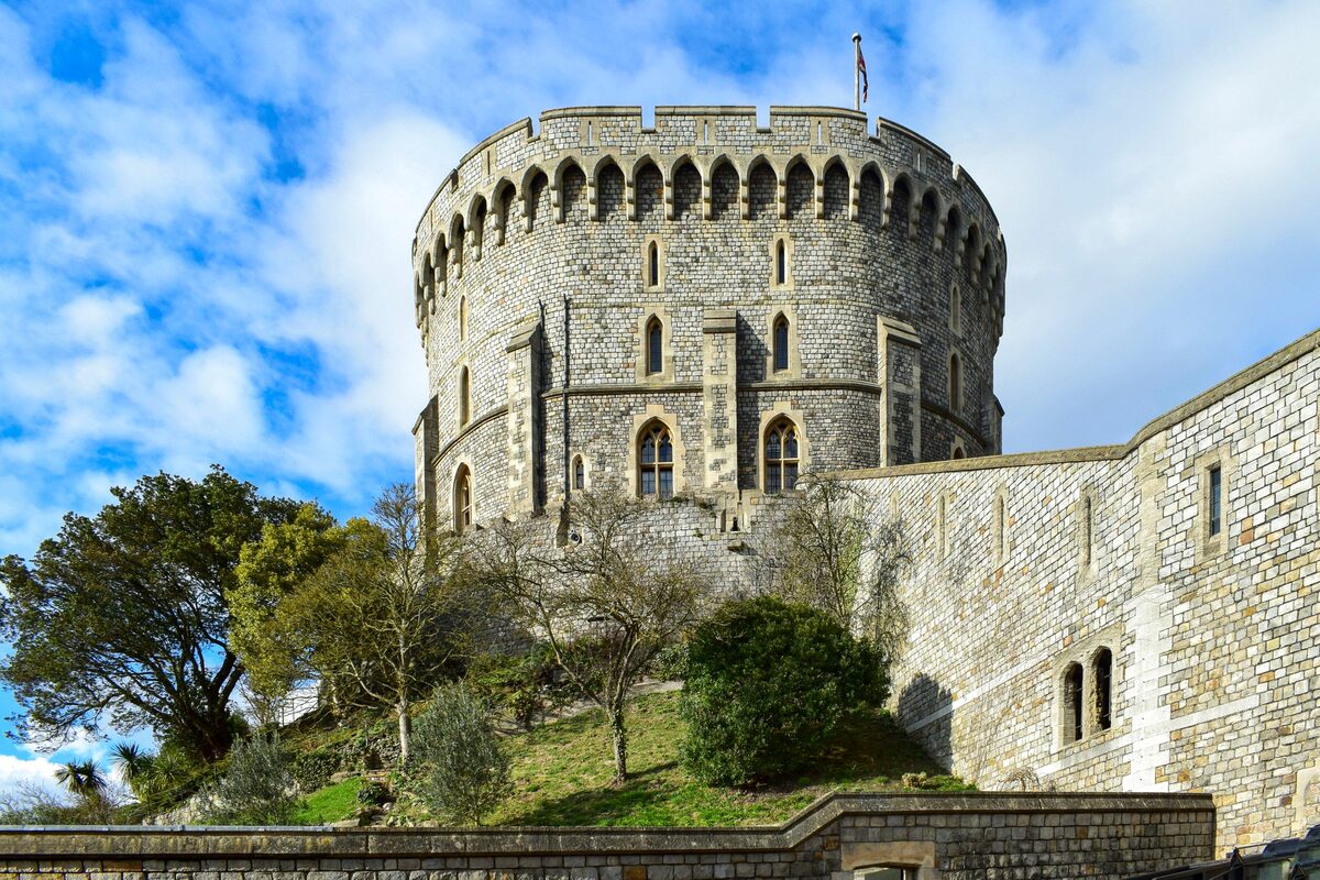 Windsor Castle with its round tower and battlements on a hill above the town
