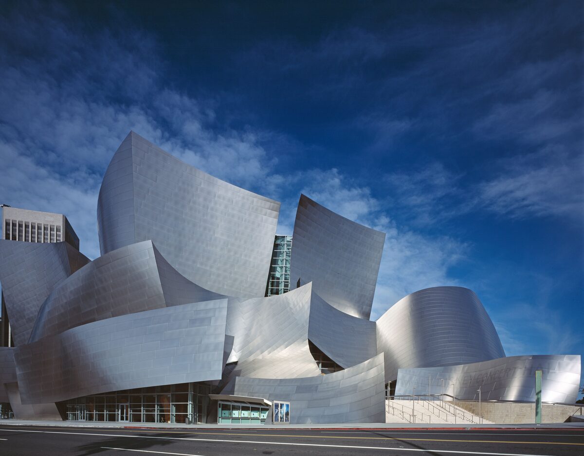 Frank Gehry's Walt Disney Concert Hall, curved stainless steel panels against a deep blue sky