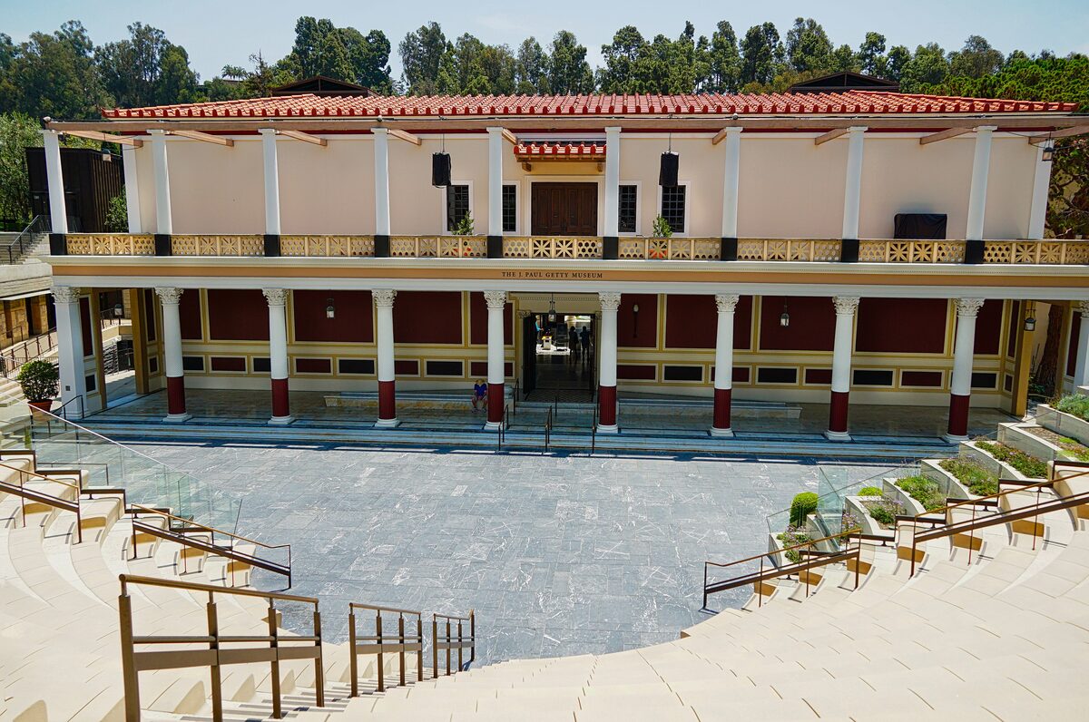 The Getty Villa, a replica Roman villa with columns and a red tile roof above an outdoor theater