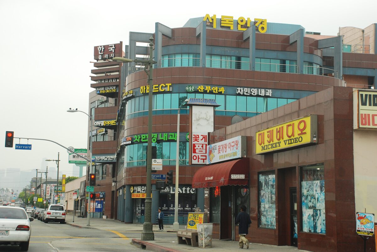 Korean-language shop signs on a street corner at Olympic Boulevard and Harvard Boulevard in Koreatown