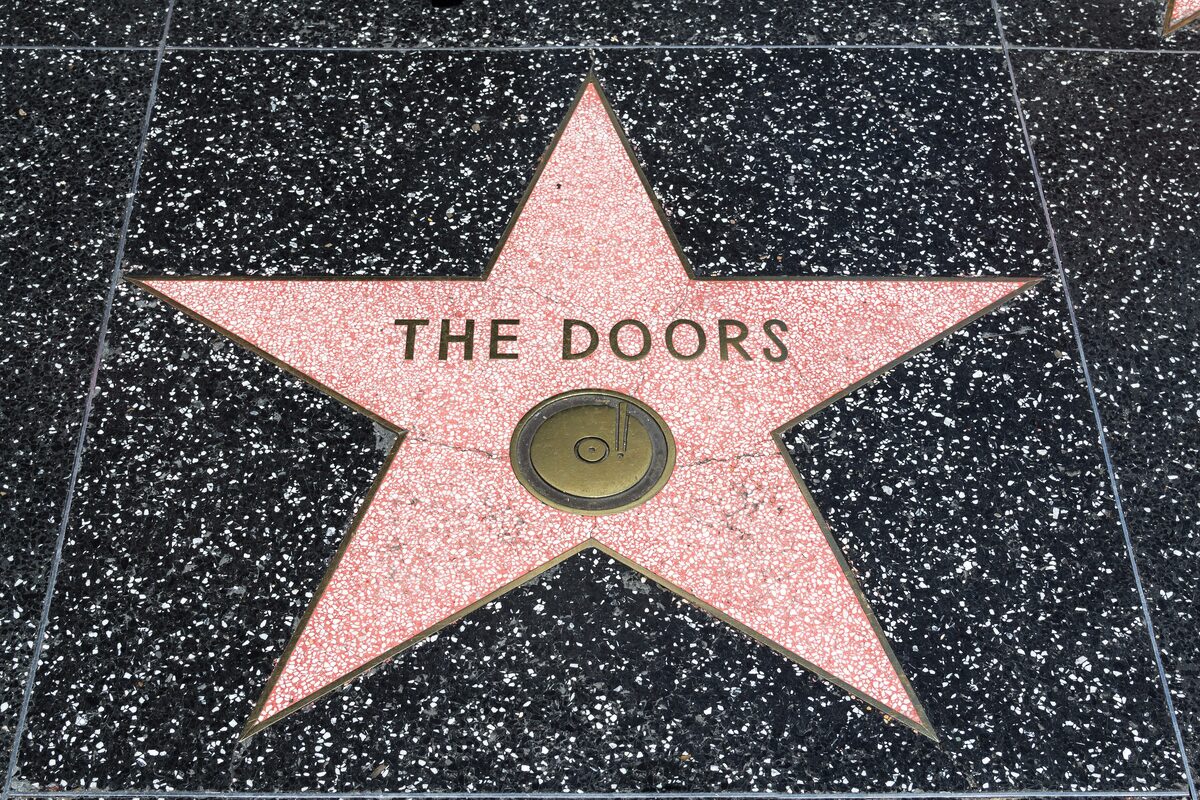 A pink terrazzo star for The Doors set in the black pavement of the Hollywood Walk of Fame