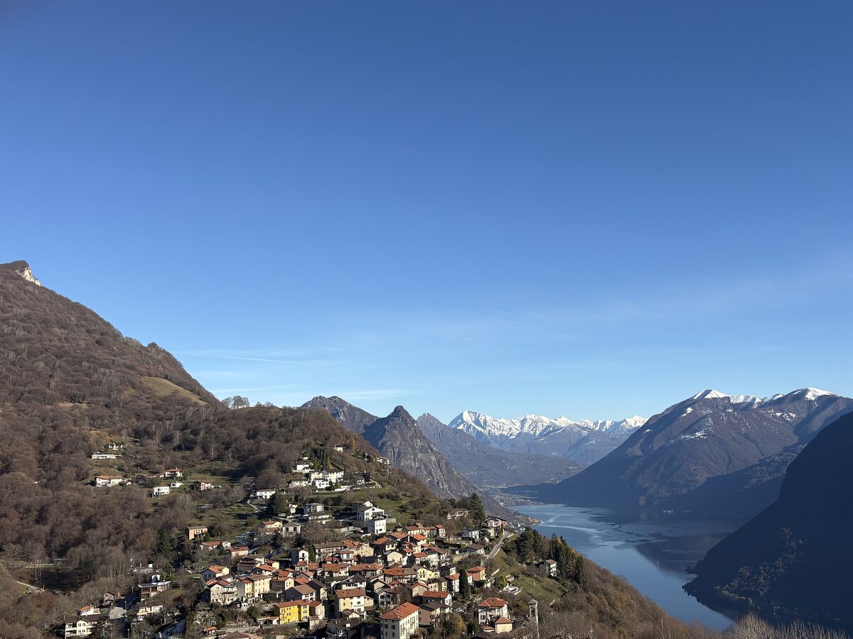 Brè's houses stacked on the hillside above Lake Lugano, with mountains rising beyond the water