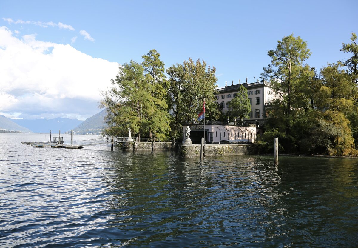 The landing stage and Villa Emden on the Brissago Islands, with trees along the lakeshore