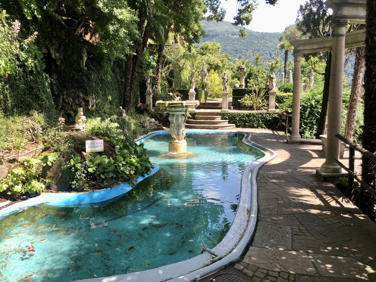 A turquoise fountain pool and stone columns in the garden of Parco Scherrer above Morcote