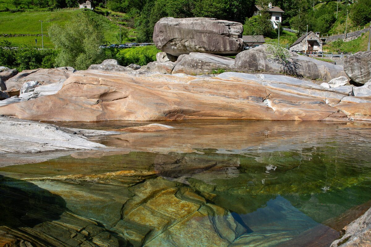 Smooth granite slabs and boulders beside clear green water in the Verzasca river at Lavertezzo
