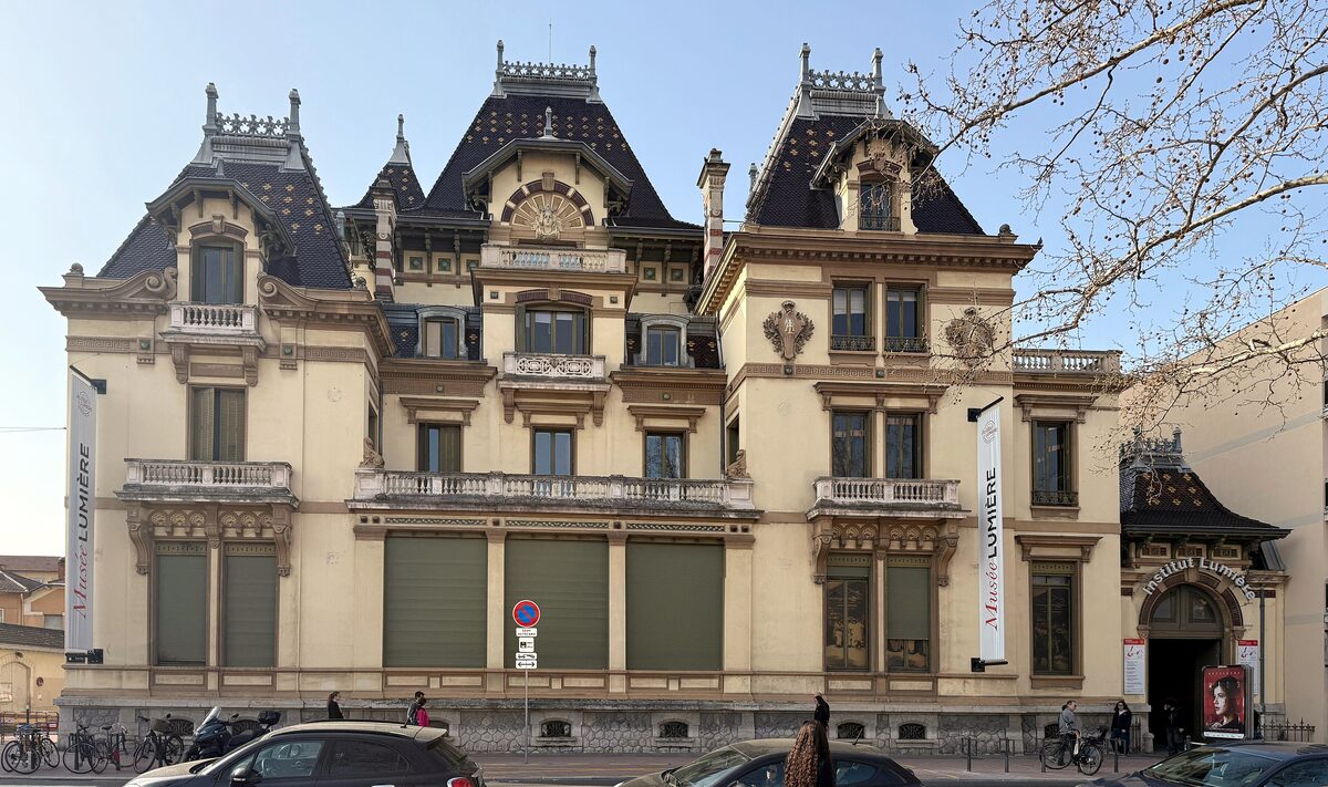 The ornate Villa Lumière with its tall slate roofs and turret, on a street in the Monplaisir district of Lyon