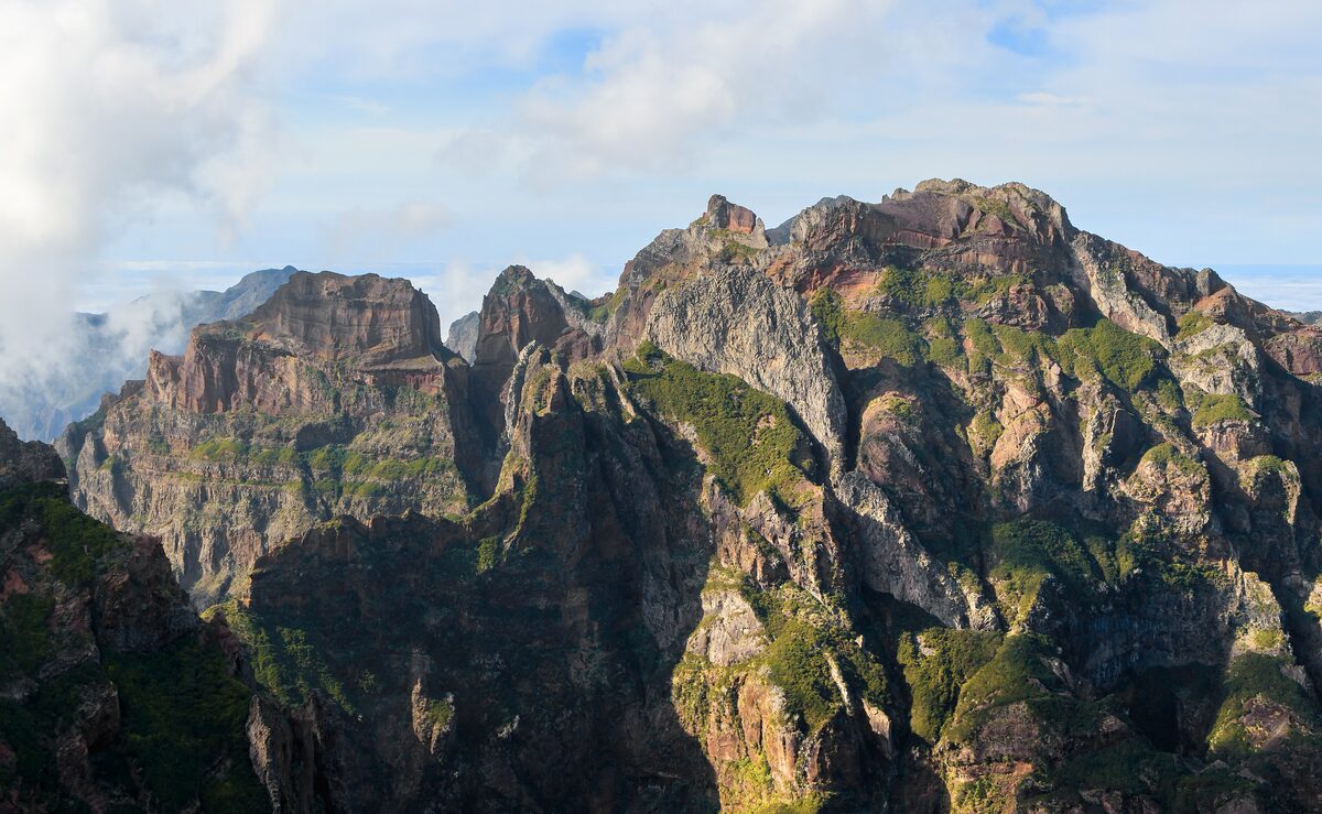 Jagged dark peaks and green gullies of the central mountains, seen from the Pico do Arieiro viewpoint