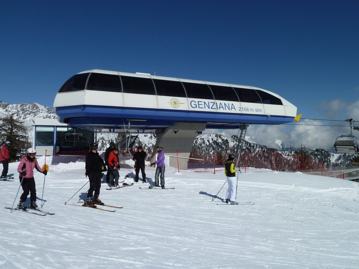The Genziana chairlift station with skiers in the snow in front of it
