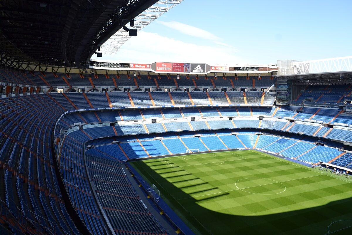 The empty seats and pitch of the Santiago Bernabéu stadium, seen from the upper tier