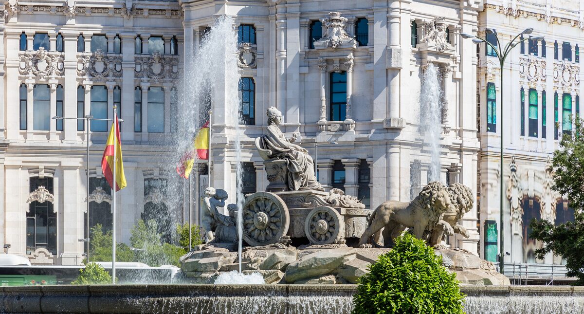 The Cibeles fountain with its marble goddess on a chariot pulled by lions, in front of the Palacio de Comunicaciones