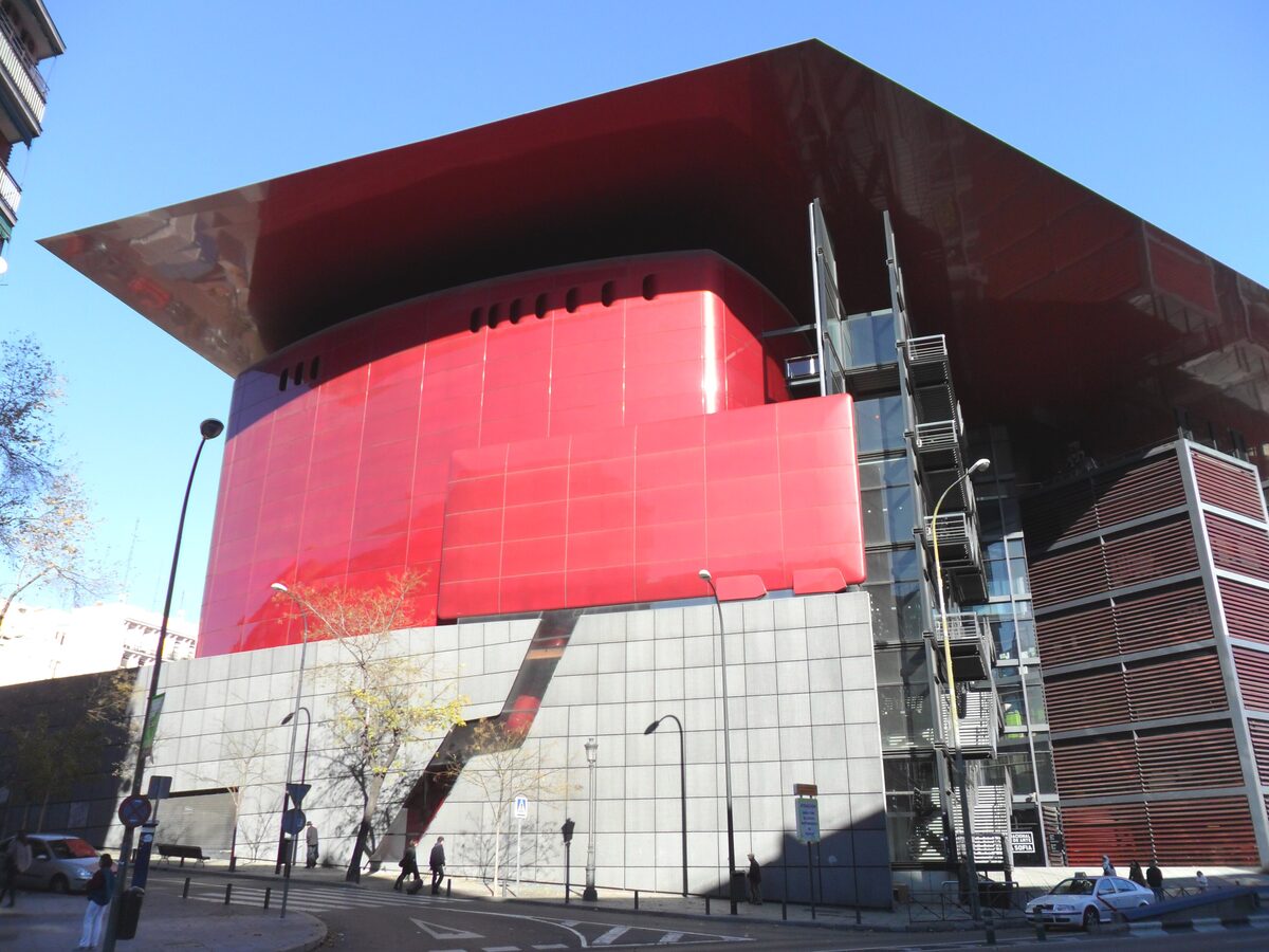 The Nouvel wing of the Reina Sofía, a red glass-and-steel block on a city street