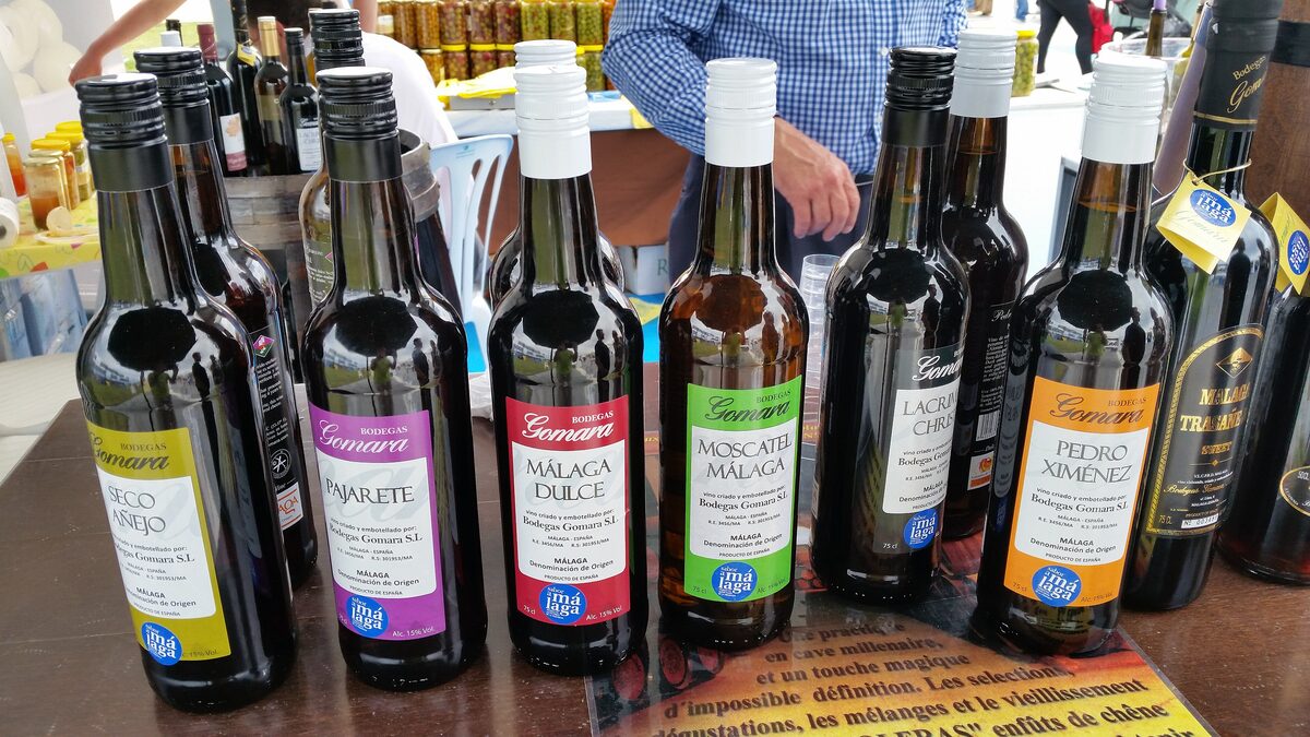 Bottles of Málaga sweet wine, including Málaga dulce, Moscatel and Pedro Ximénez, on a tasting counter