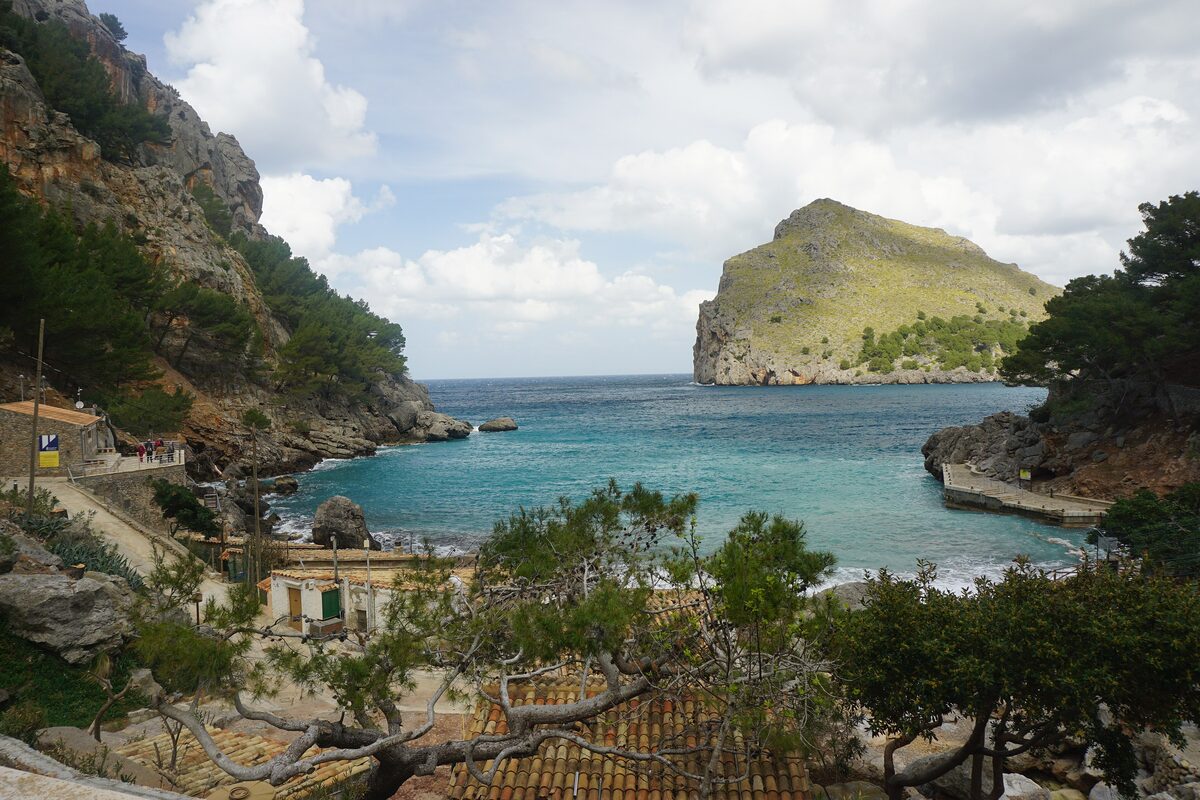The small port of Sa Calobra, a rocky cove with white houses along the shore and the cliffs rising behind