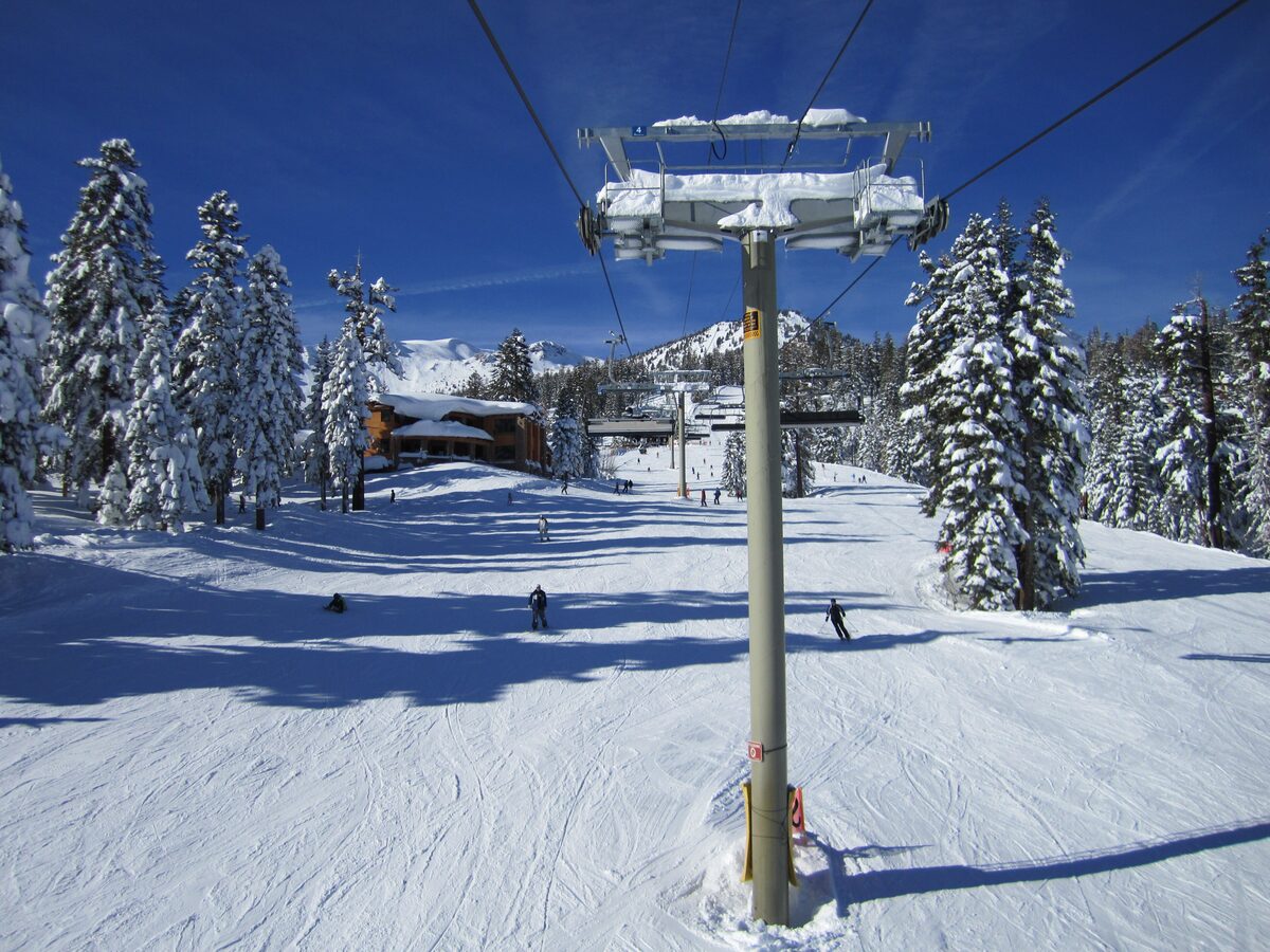 The Eagle Express chairlift above a groomed run with snowy pines