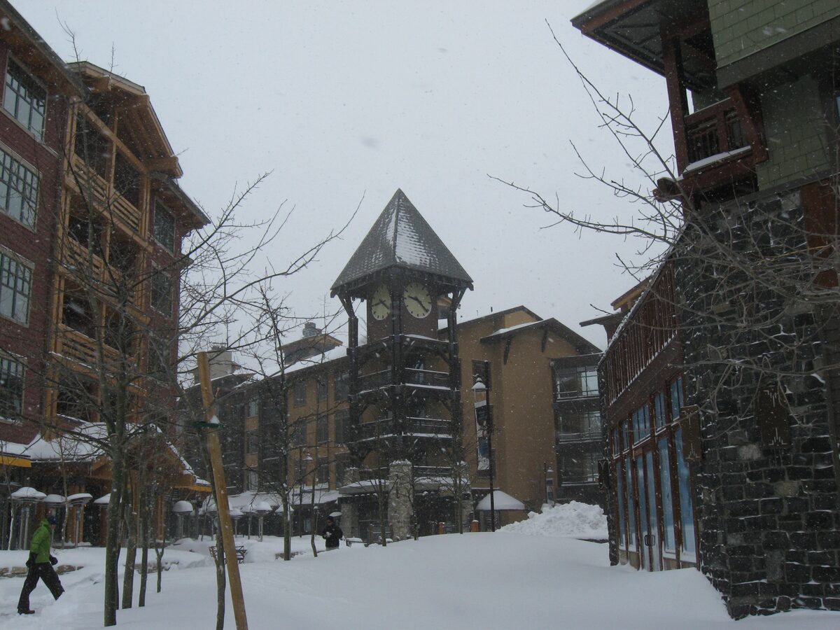 A clock tower and lodgings in the Village at Mammoth after snow