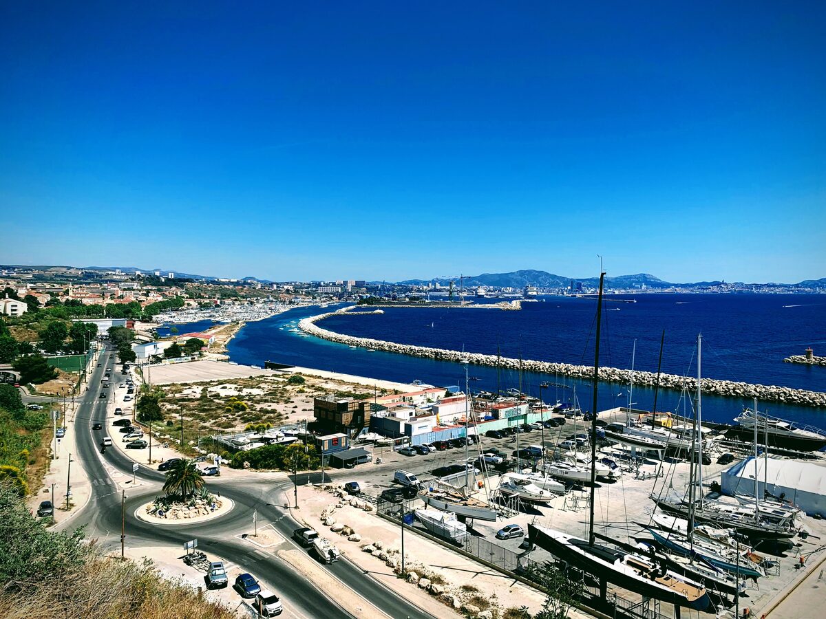 The harbor of L'Estaque with its marina and breakwater, and the sea beyond
