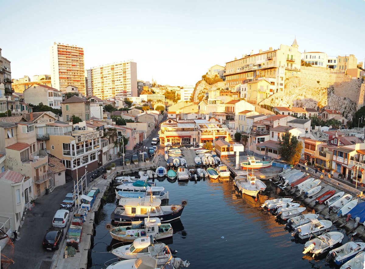 Small fishing boats moored in the Vallon des Auffes, a tucked-away harbor between the rocks and the houses
