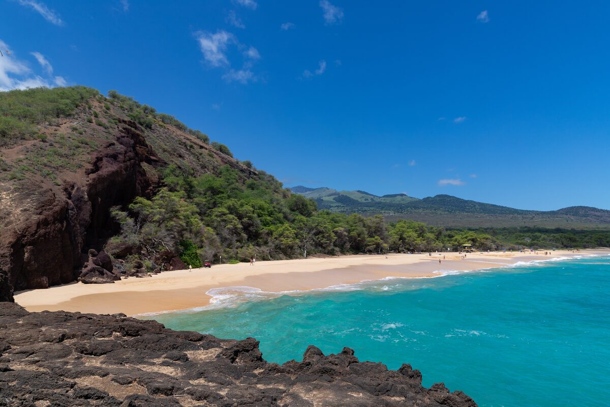 Big Beach at Mākena seen from the rocks, with turquoise water and a long pale shore
