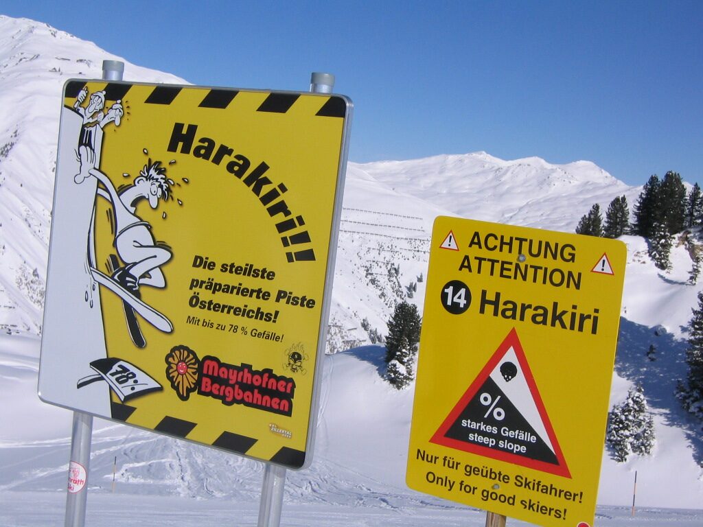 The yellow Harakiri sign at the start of the piste, calling it the steepest groomed piste in Austria, with a warning for good skiers only