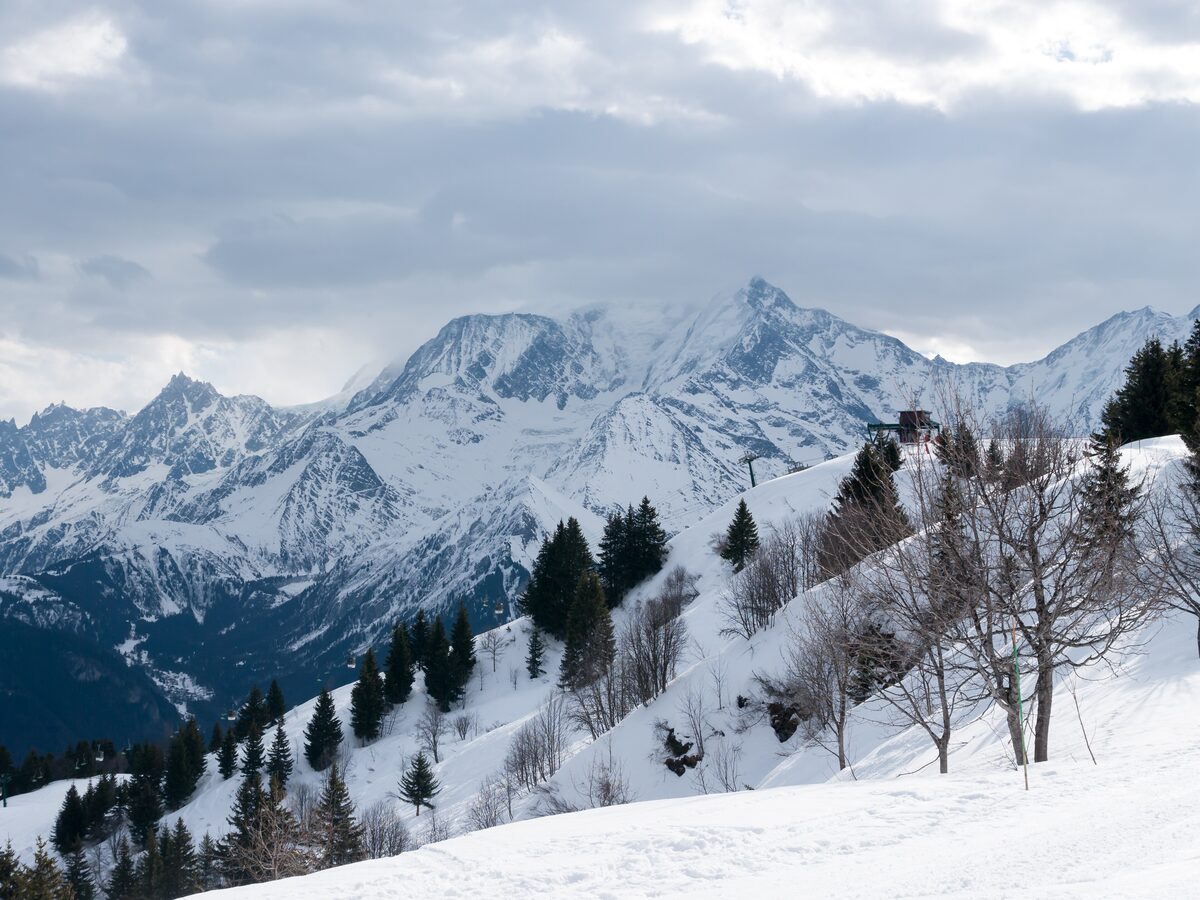 Snow-covered slopes with the Mont Blanc massif rising behind Saint-Gervais