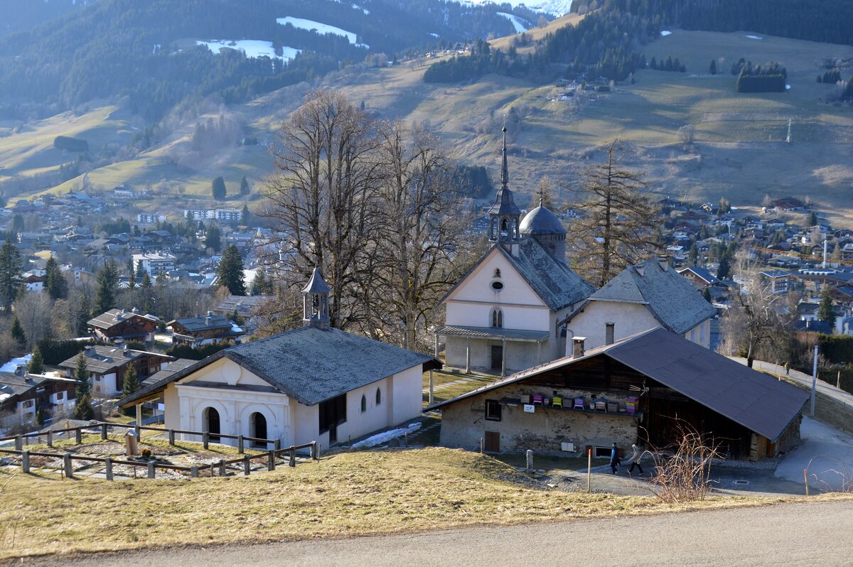 The white chapels of the Calvary on the hill above Megève, with the village roofs below