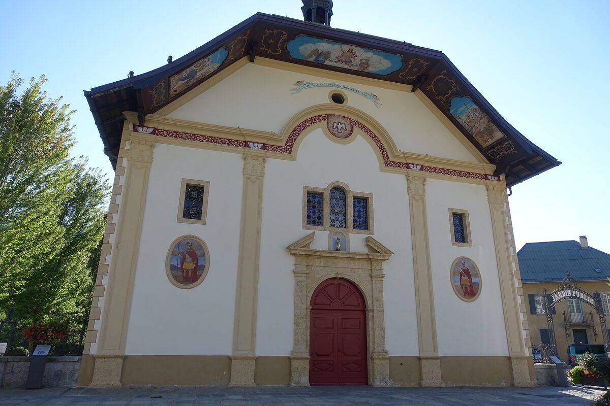 Painted wooden canopy and white facade of the Baroque church of Saint-Gervais-Saint-Protais
