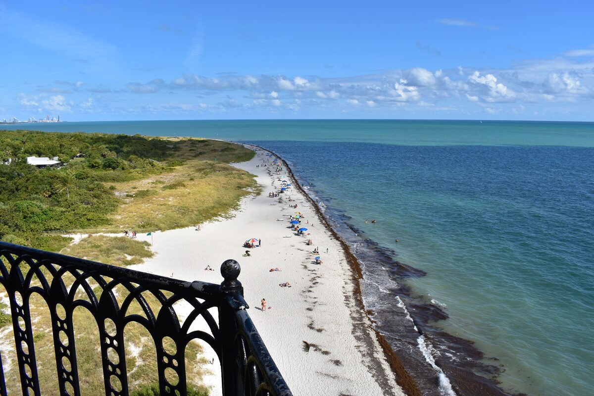 The beach at Bill Baggs Cape Florida State Park seen from the lighthouse gallery, white sand curving beside turquoise water