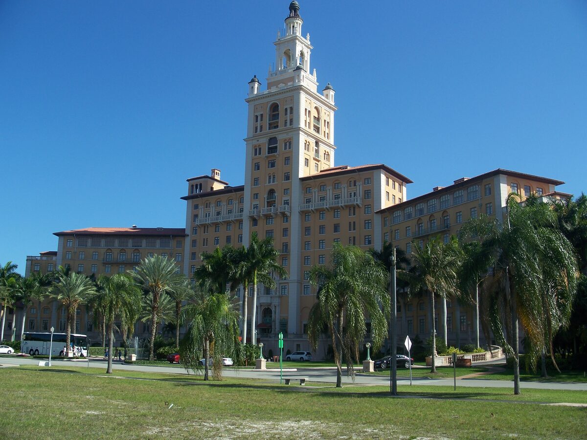 The Miami Biltmore Hotel in Coral Gables, its tall tower rising above the palms under a blue sky