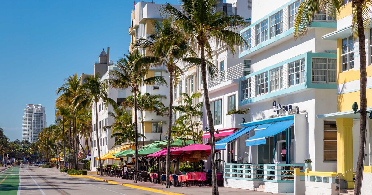Pastel Art Deco hotels along Ocean Drive in South Beach, with palm trees and the beach beside the street