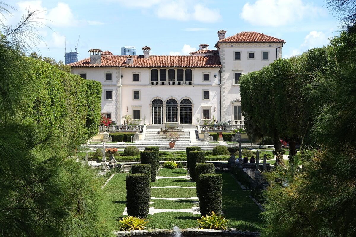 The Vizcaya villa with its red tile roof, seen across clipped hedges and the formal gardens