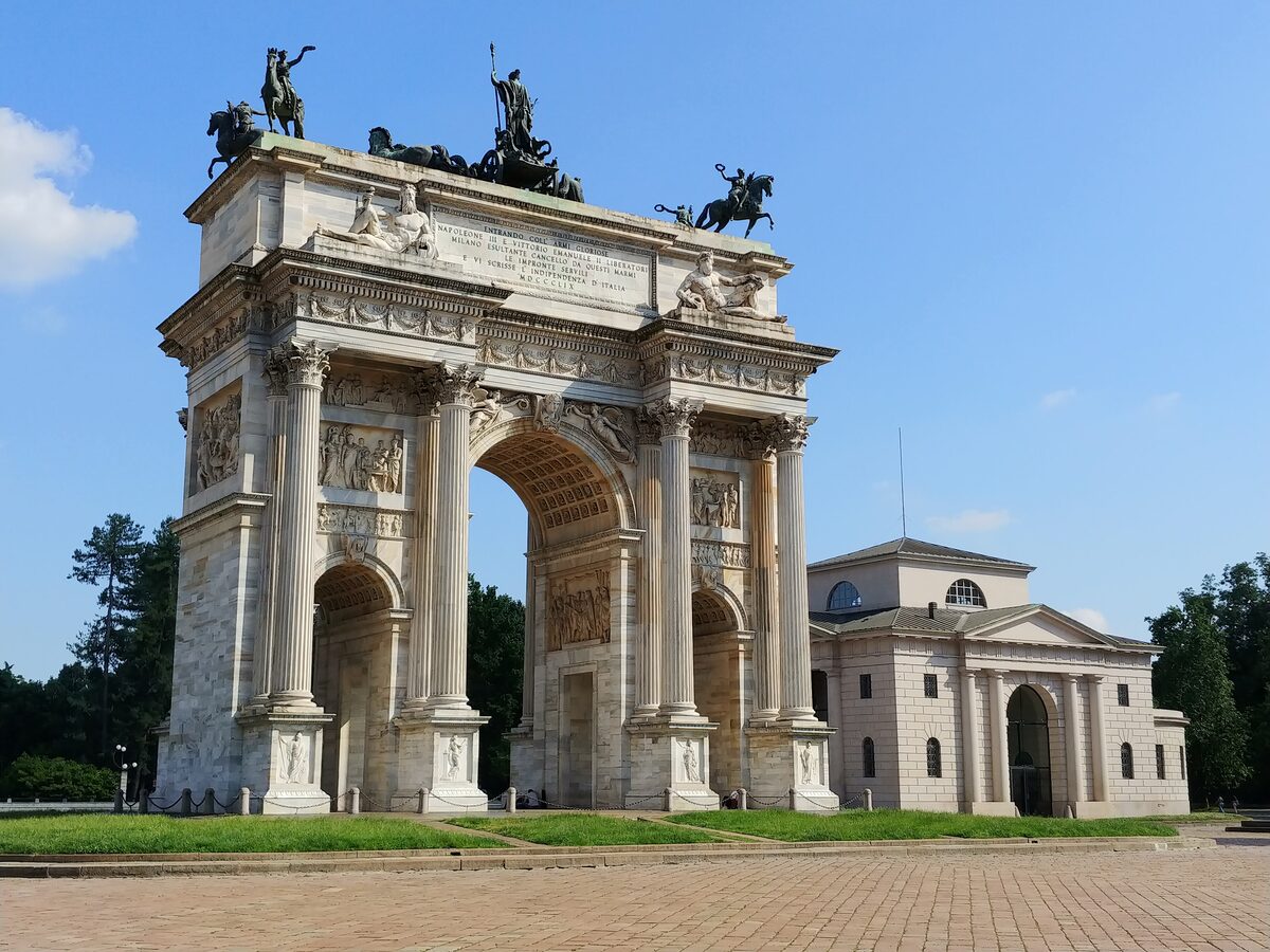 The Arco della Pace and its bronze chariot against a blue sky
